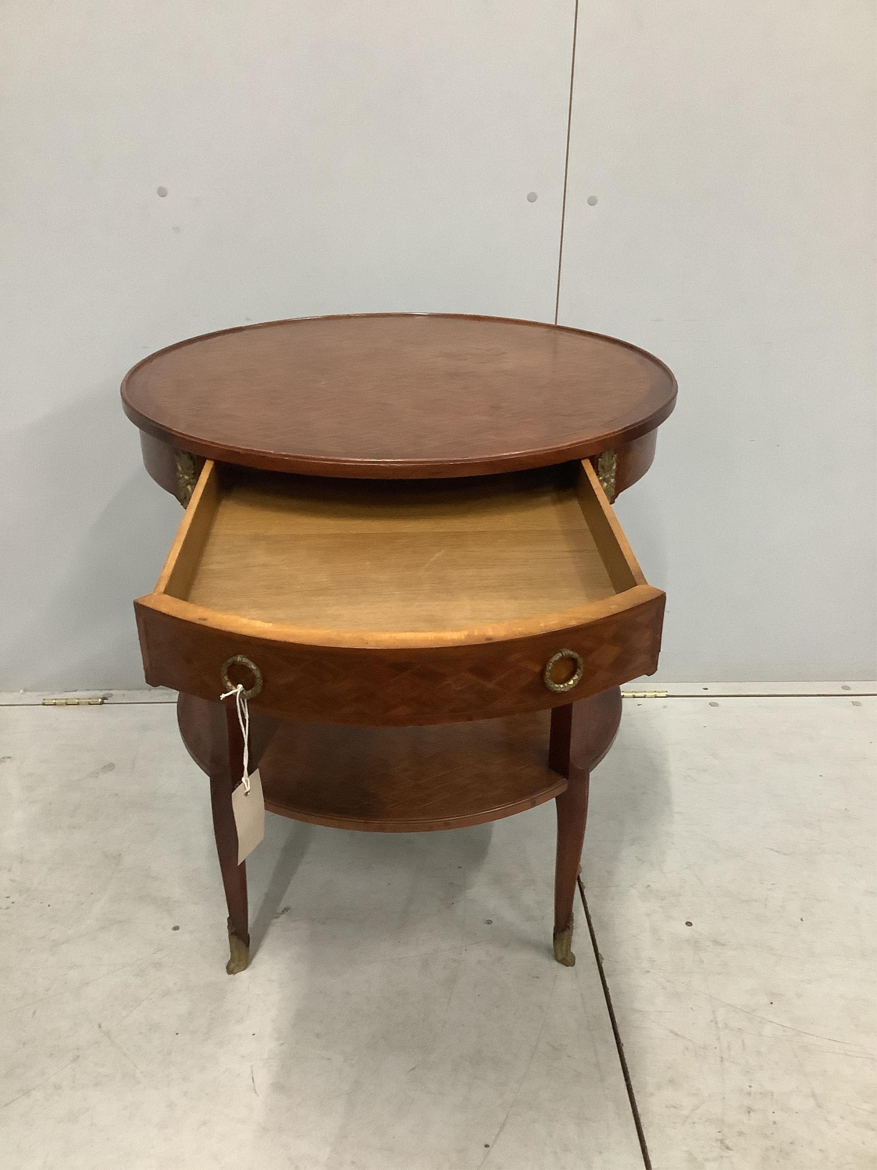 A French transitional style gilt metal mounted circular two tier occasional table, diameter 66cm, height 75cm. Condition - fair